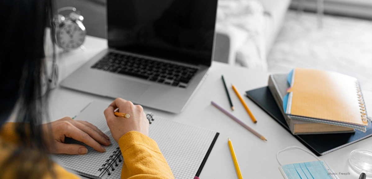 Talking About Your Daily Routine in English for Beginners, a girl studying and writing on her notebook