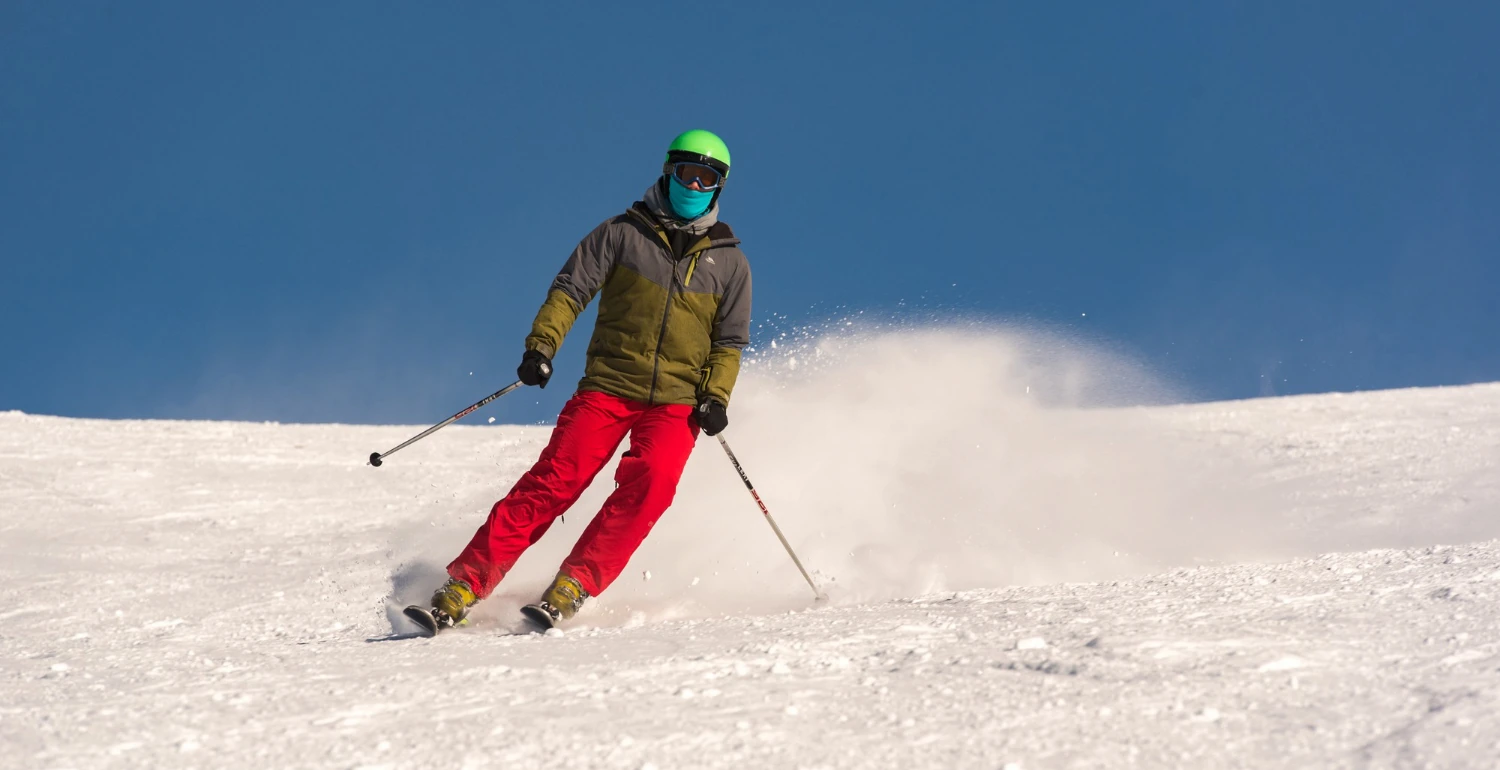 English Conversation Topics About Hobbies A Useful Guide, an image of a man skiing in a snowy mountain