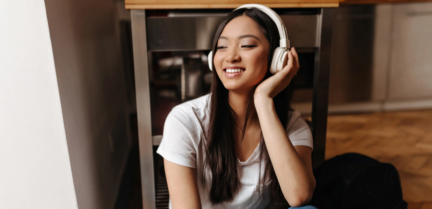 English Conversation Topics About Hobbies A Useful Guide, a teenage girl with a headphones on, listening to music as her hobby