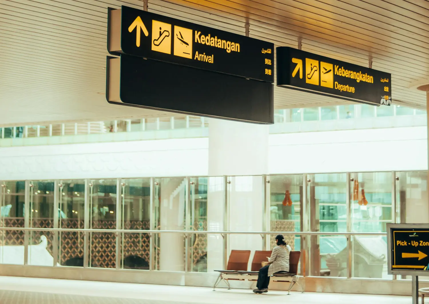 Essential English Phrases for Airport Conversations A Guide for a Smooth Trip, a passenger siting at the airport arrival lounge