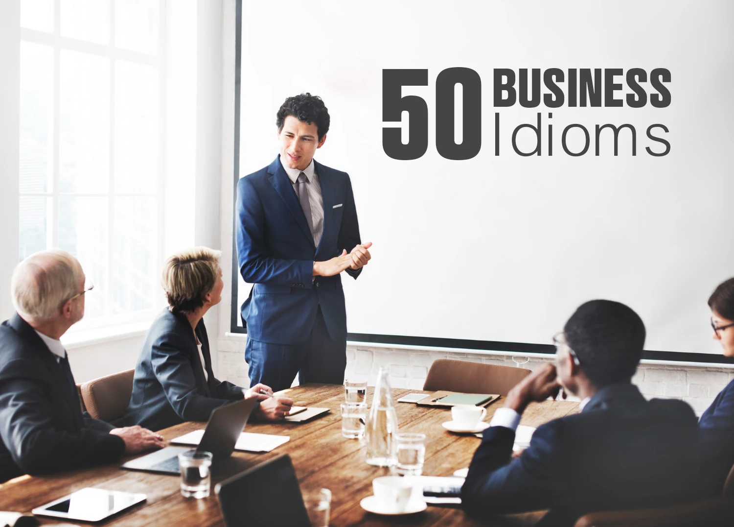 Master 50 Common Business Idioms for ESL. A team of businessmen having a meeting.